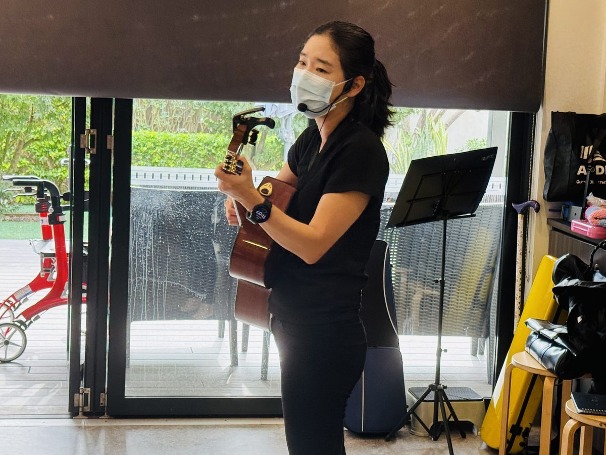 Music therapist playing guitar in a session